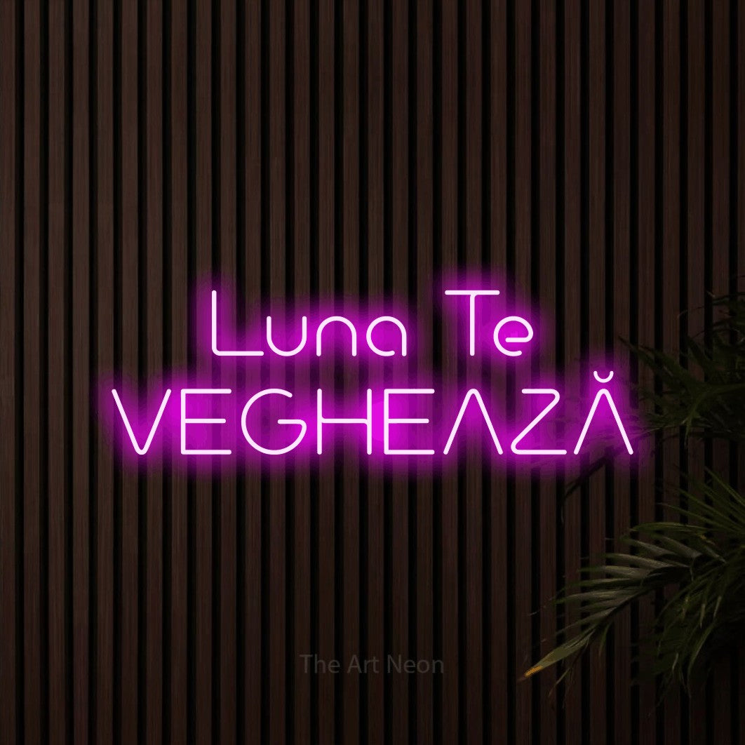 LED neon sign reading “Luna Te VEGHEAZĂ”, arranged in two lines.