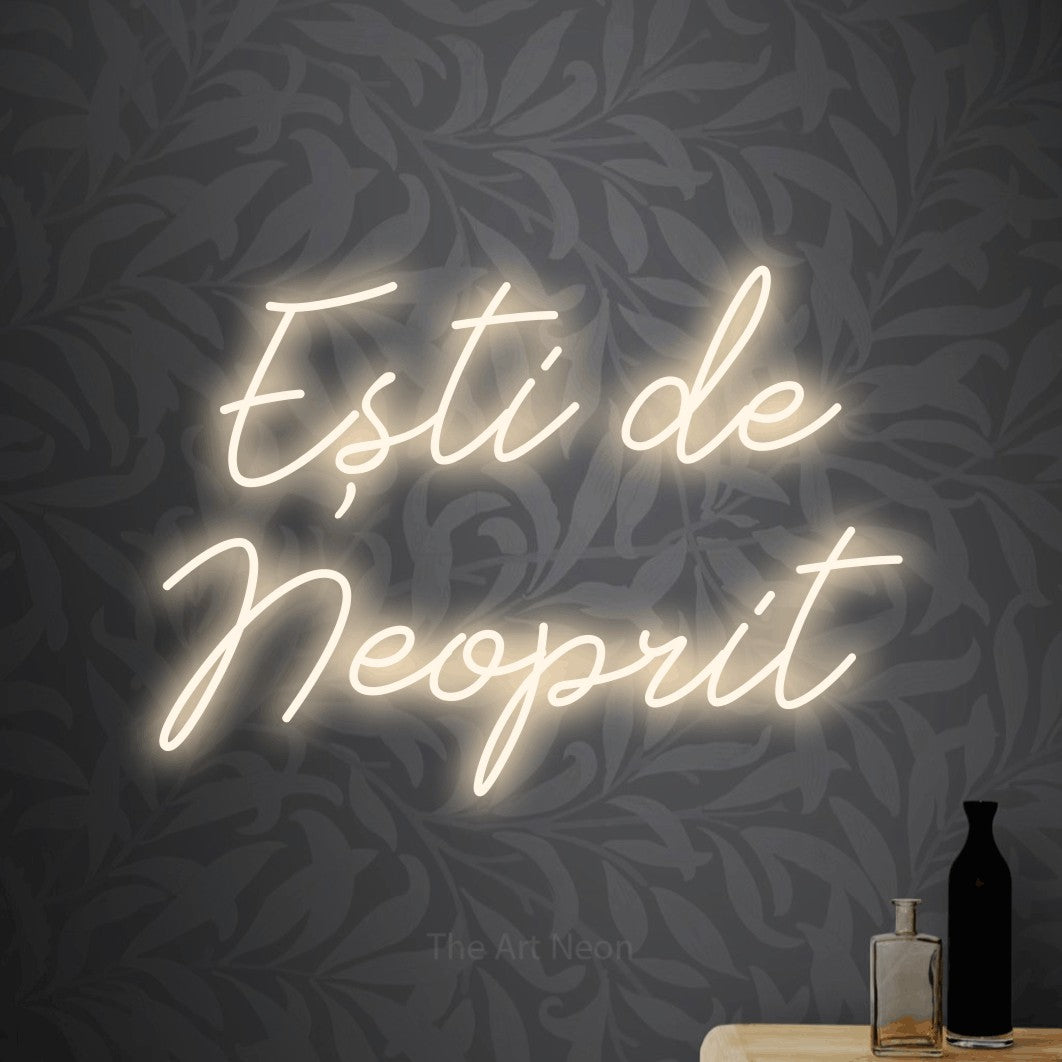 LED neon sign reading “Ești de Neoprit”, arranged in two lines.