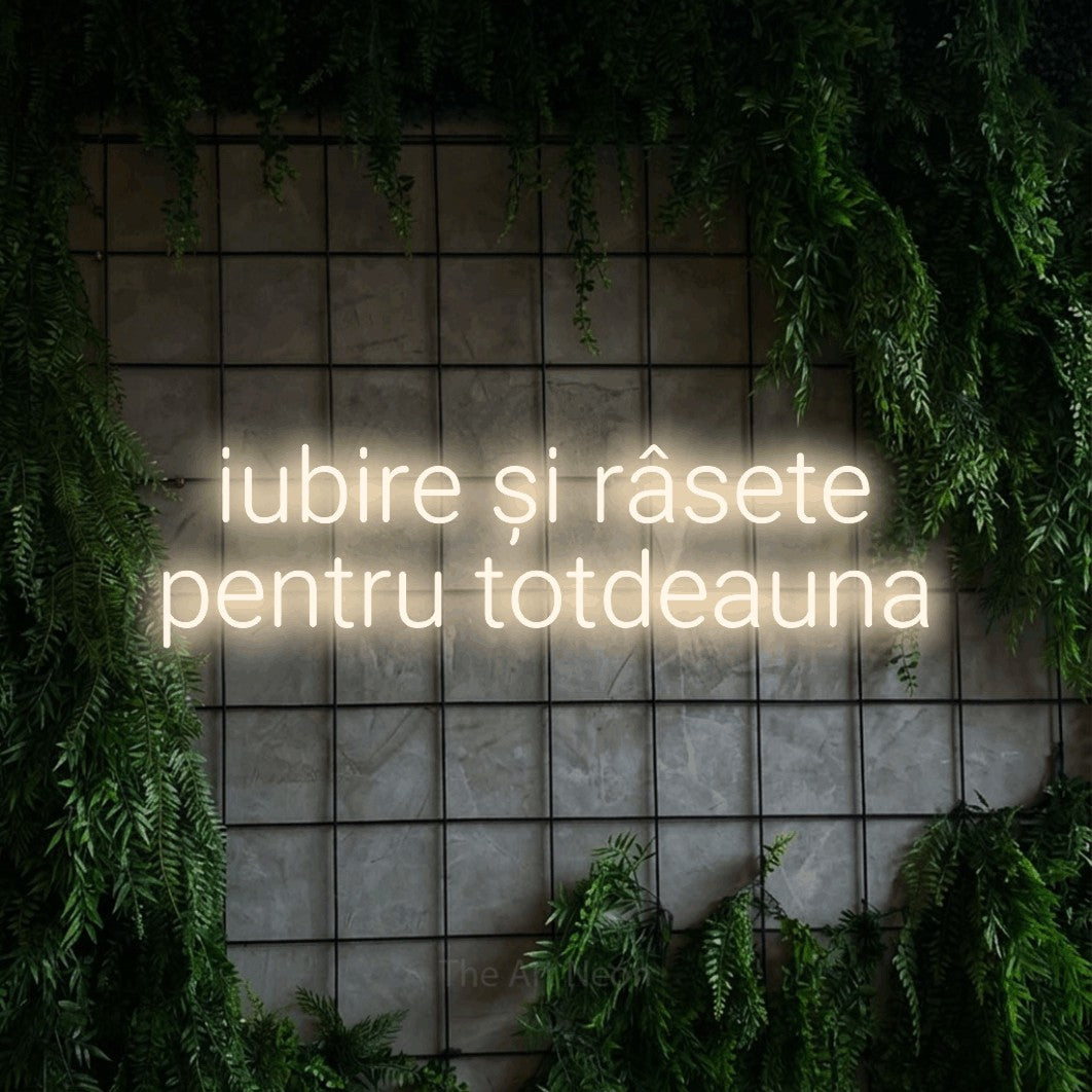 LED neon sign reading “iubire și râsete pentru totdeauna”, arranged in two lines.