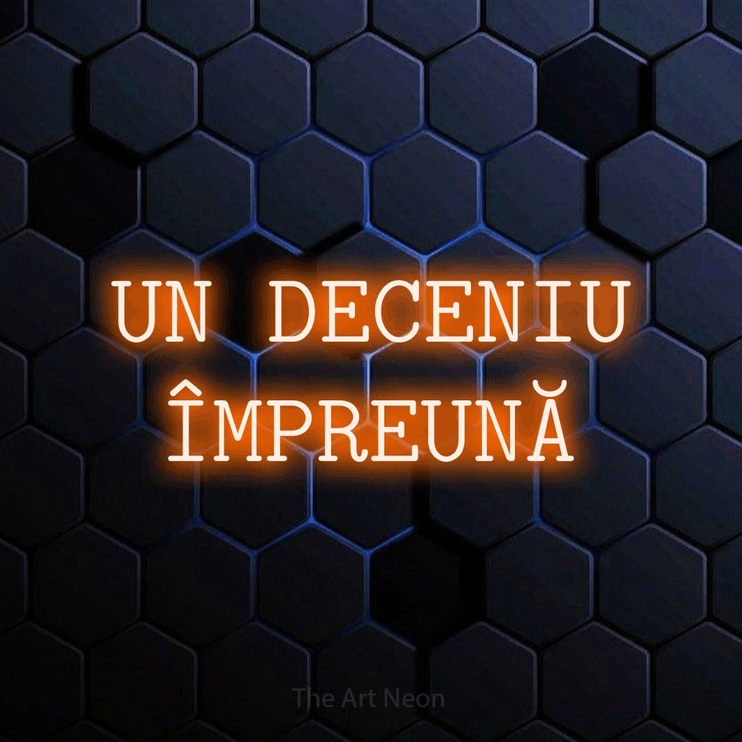 LED neon sign reading “UN DECENIU ÎMPREUNĂ”, arranged in two lines.