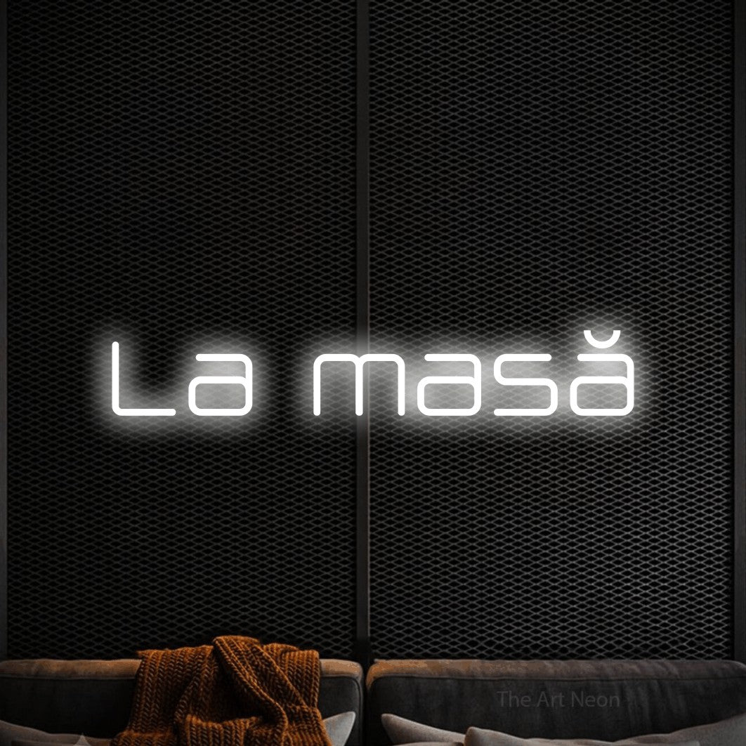 LED neon sign reading “La masă”, arranged in a single line.