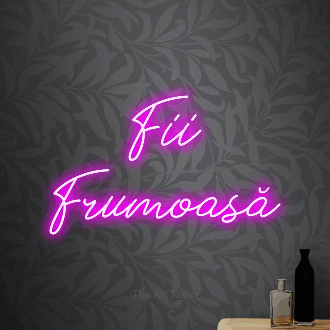LED neon sign reading “Fii Frumoasă”, arranged in two lines.