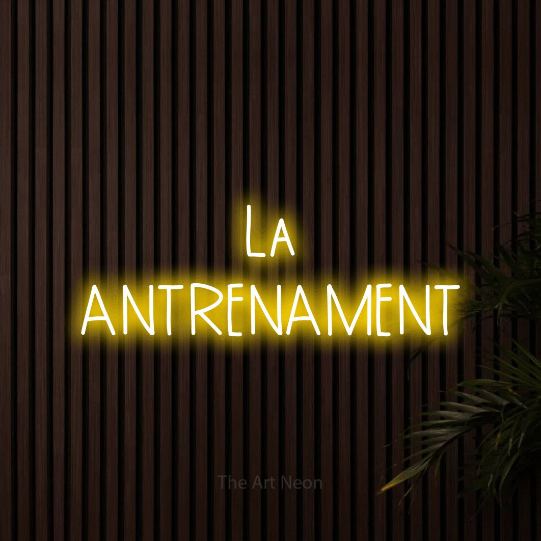 LED neon sign reading “La ANTRENAMENT”, arranged in two lines.