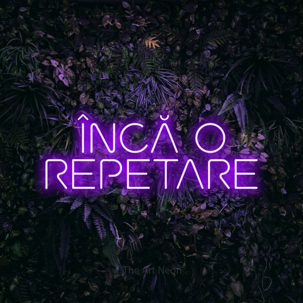 LED neon sign reading “ÎNCĂ O REPETARE”, arranged in two lines.