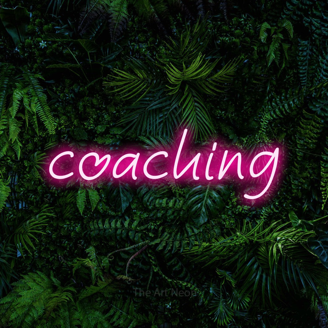LED neon sign reading “coaching”, arranged in a single line.
