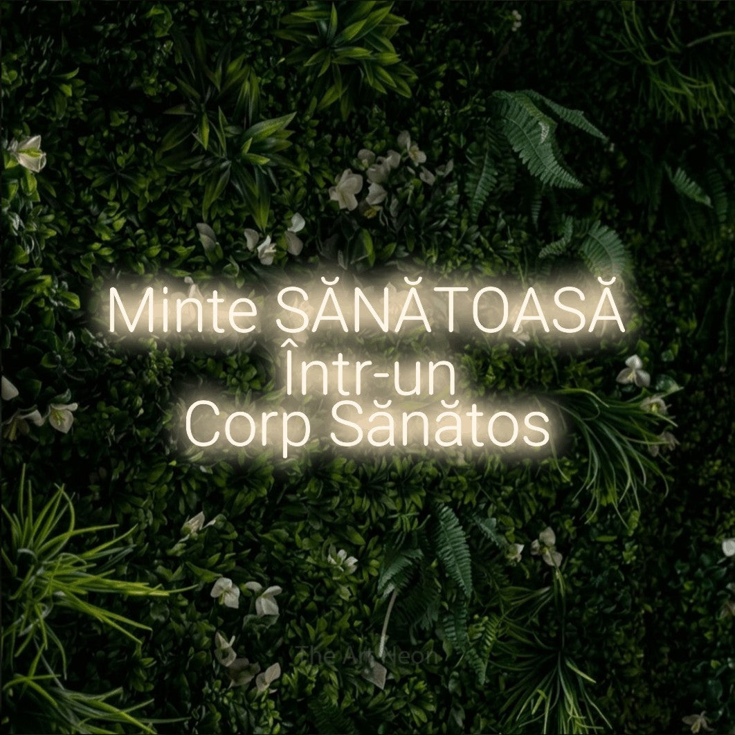 LED neon sign reading “Minte SĂNĂTOASĂ Într-un Corp Sănătos”, arranged in three lines.