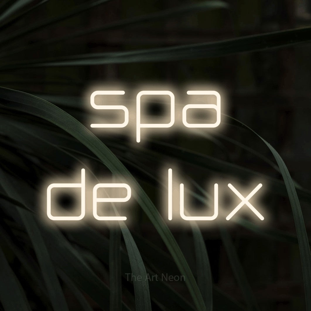 LED neon sign reading “spa de lux”, arranged in two lines.