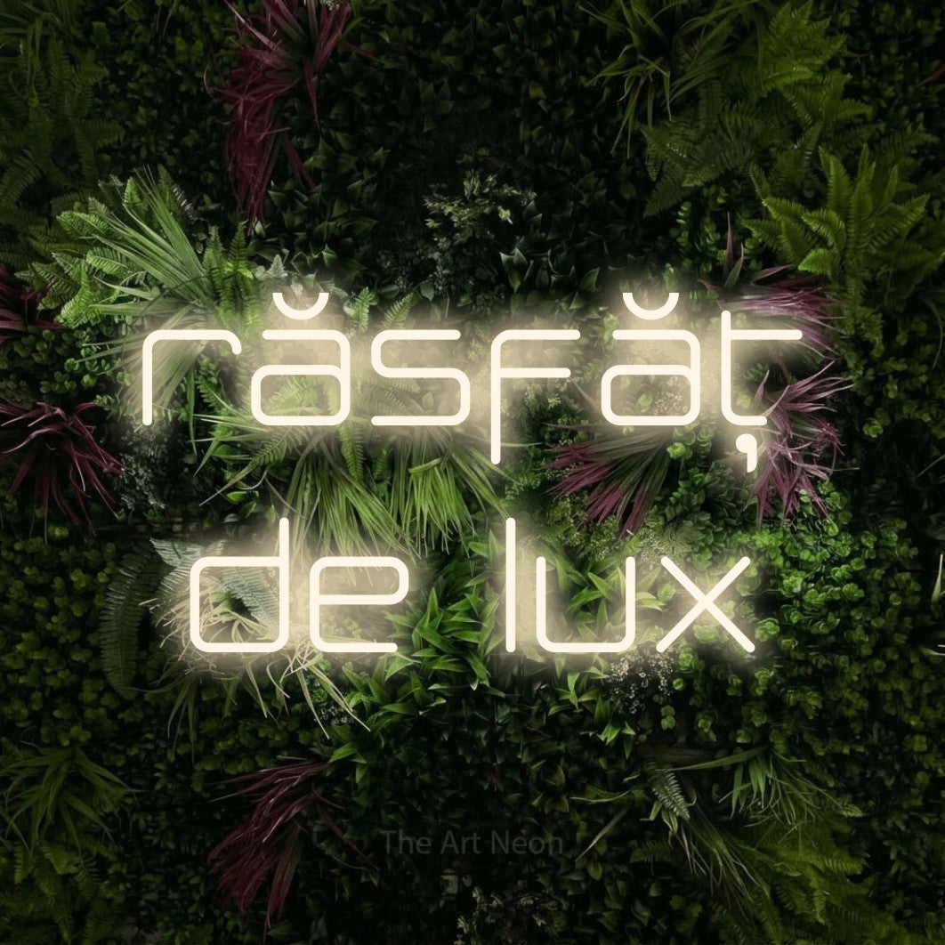 LED neon sign reading “răsfăț de lux”, arranged in two lines.