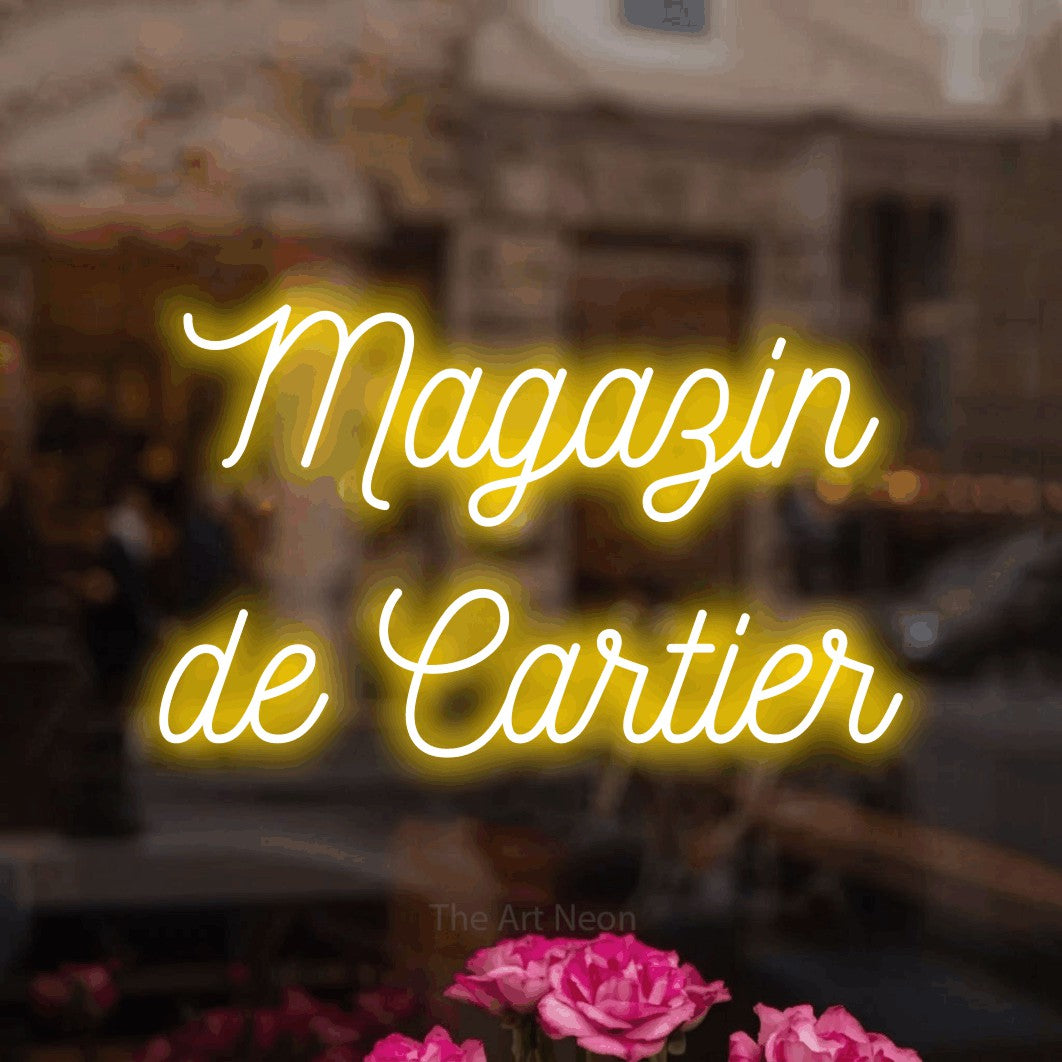 LED neon sign reading “Magazin de Cartier”, arranged in two lines.