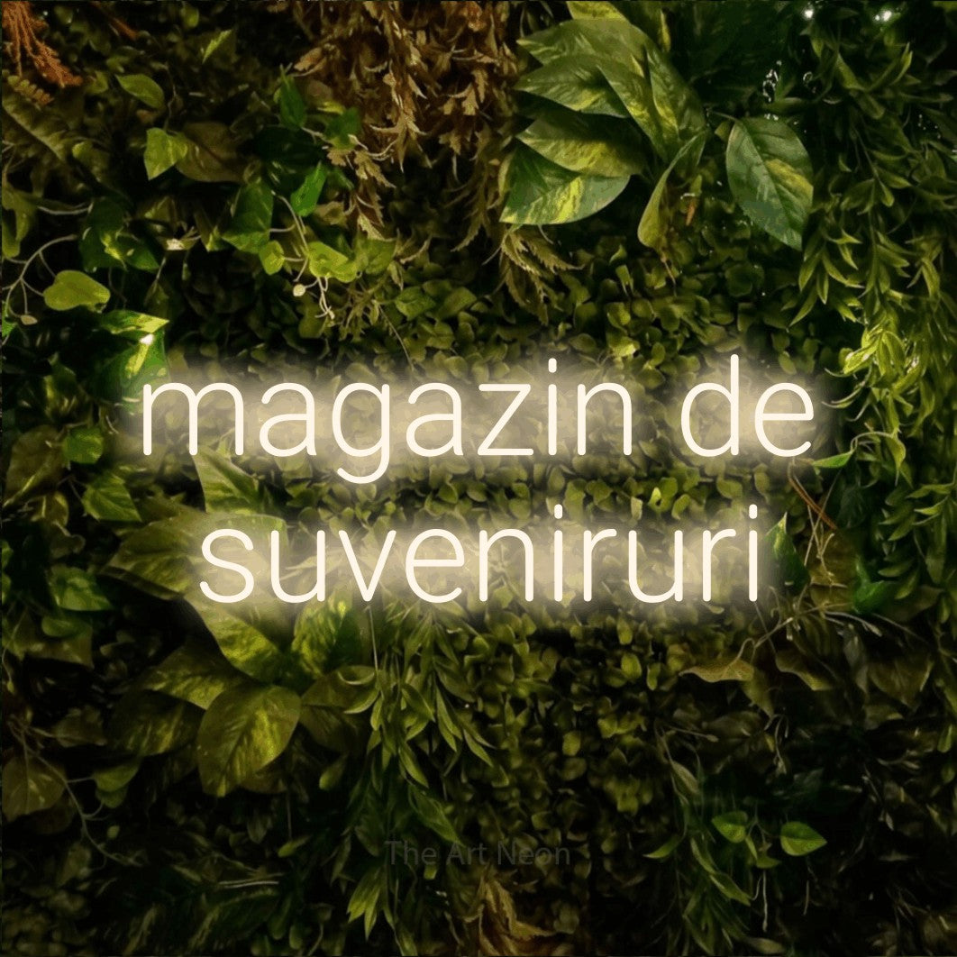 LED neon sign reading “magazin de suveniruri”, arranged in two lines.