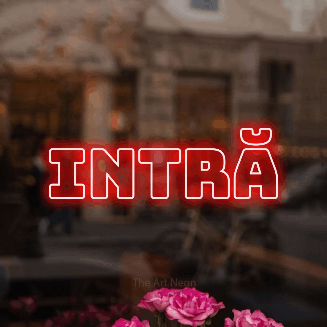 LED neon sign reading “INTRĂ”, arranged in a single line.