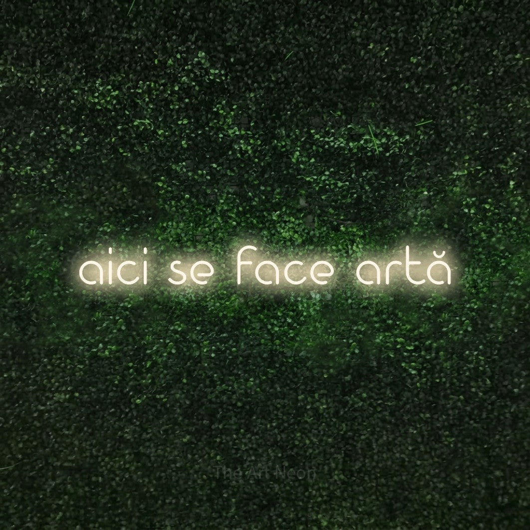 LED neon sign reading “aici se face artă”, arranged in a single line.