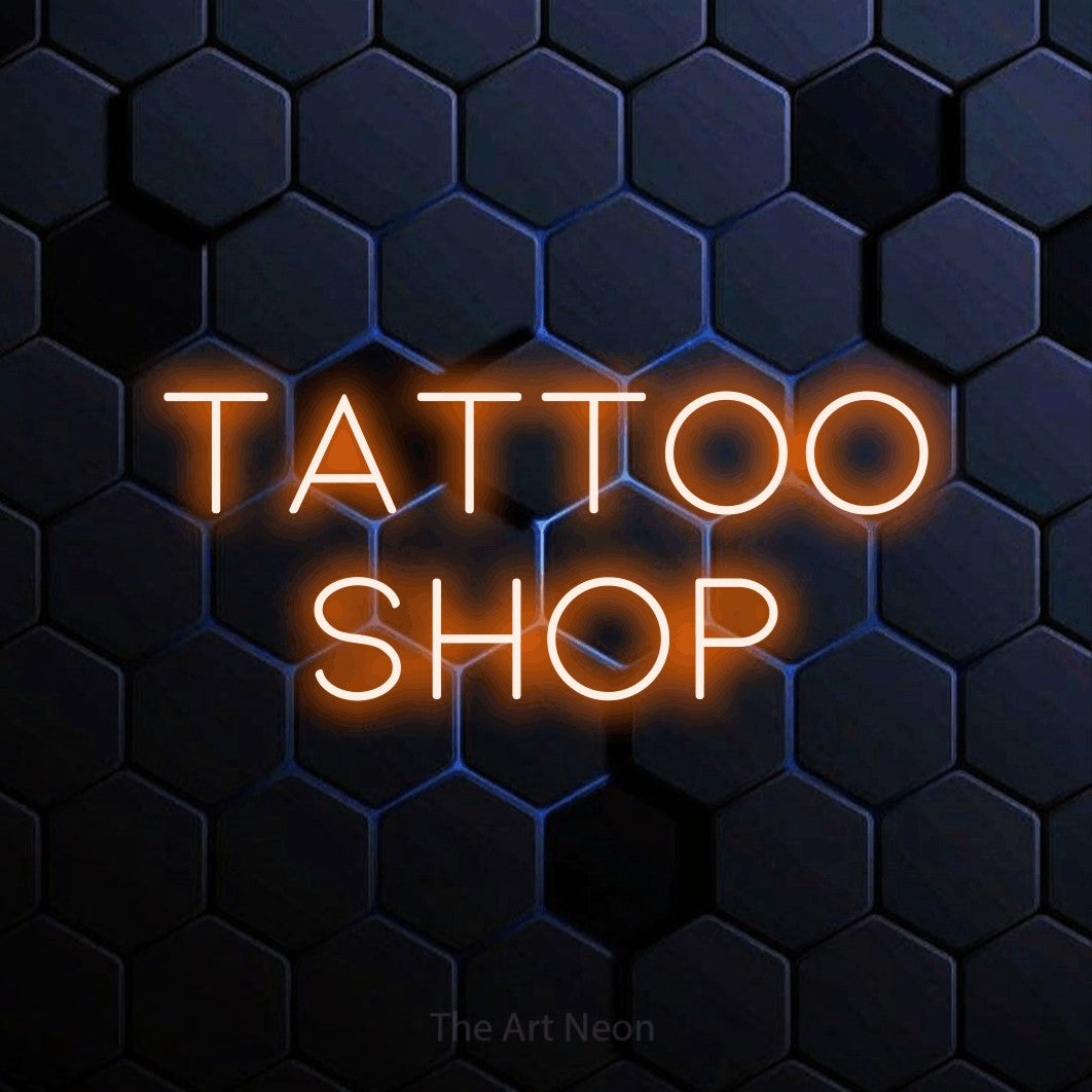 LED neon sign reading “Tattoo Shop”, arranged in two lines.