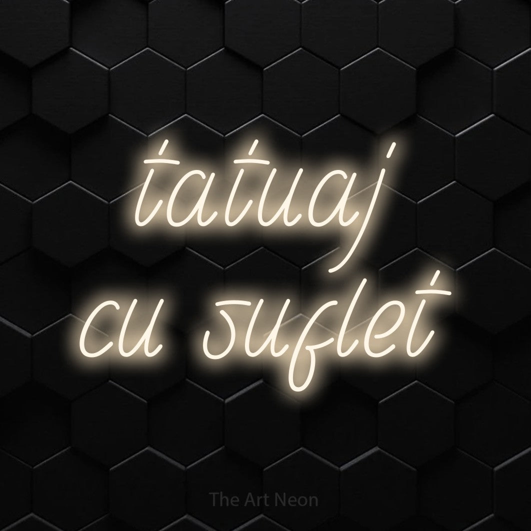 LED neon sign reading “tatuaj cu suflet”, arranged in two lines.