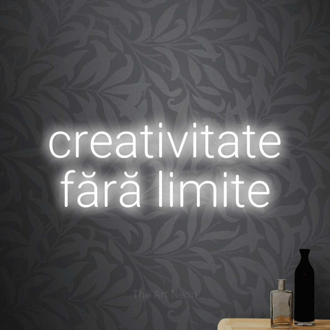 LED neon sign reading “creativitate fără limite”, arranged in two lines.