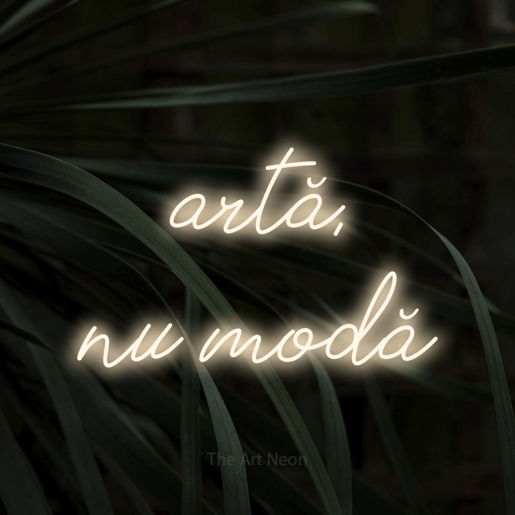 LED neon sign reading “artă, nu modă”, arranged in two lines.