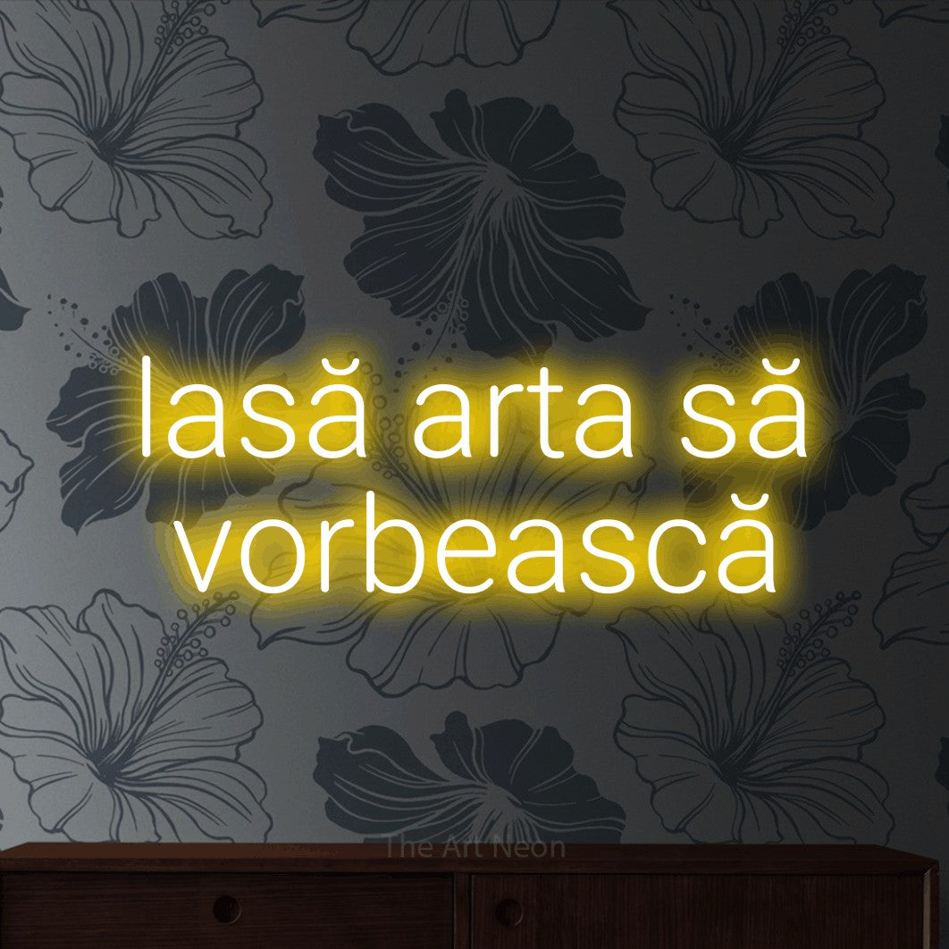 LED neon sign reading “lasă arta să vorbească”, arranged in two lines.