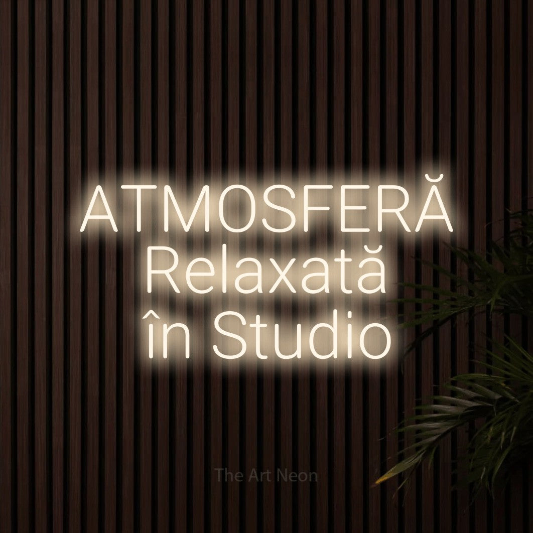 LED neon sign reading “ATMOSFERĂ Relaxată în Studio”, arranged in three lines.