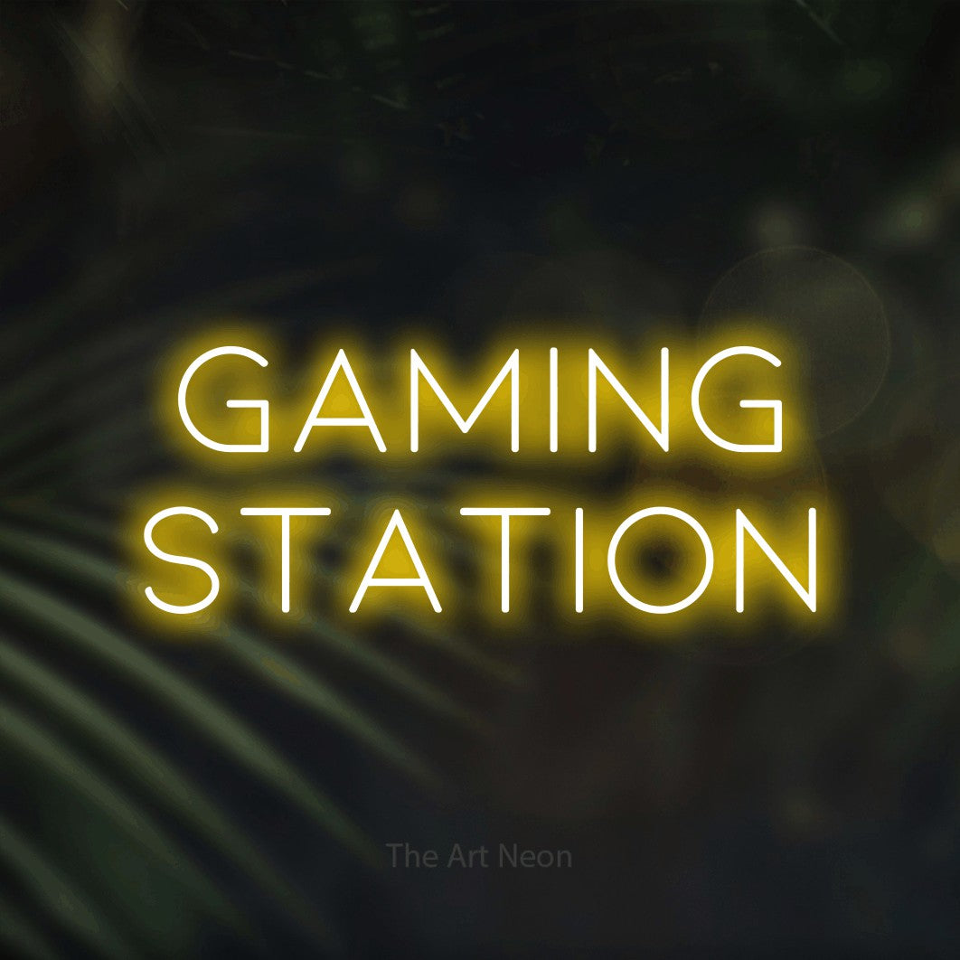 LED neon sign reading “gaming station”, arranged in two lines.