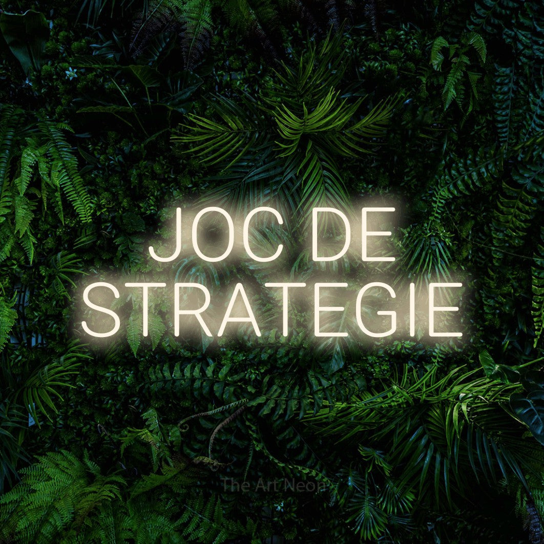 LED neon sign reading “JOC DE STRATEGIE”, arranged in two lines.