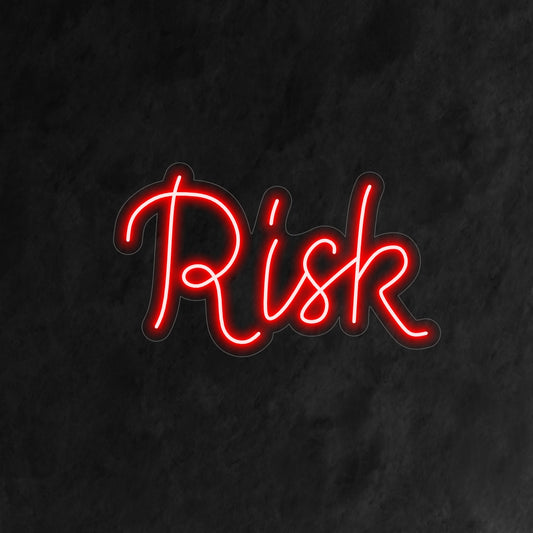 "Risk Neon Sign" boldly illuminates the word 'Risk', infusing your space with a sense of adventure and daring spirit."