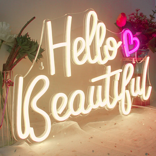 A képen egy élénk, szemet gyönyörködtető "Hello Beautiful" LED fényreklám látható.
