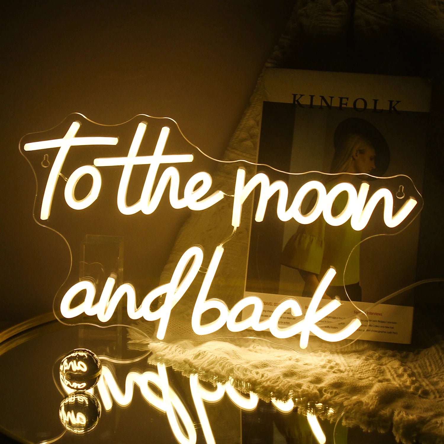 The image features a handmade LED neon sign displaying the phrase "To The Moon And Back" in elegant, cursive lettering.