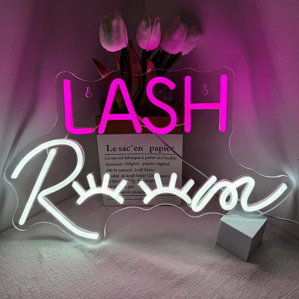 The image features a vibrant LED neon sign displaying the words "Lash Room" in a stylish cursive font.