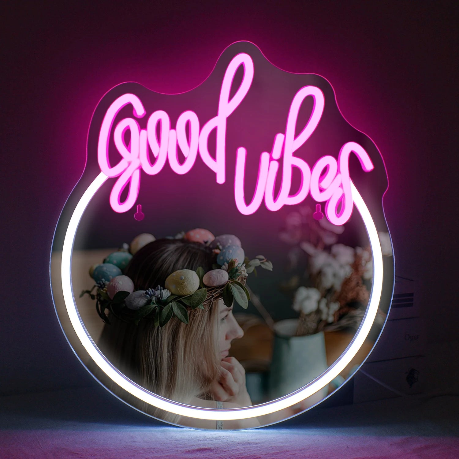 The image displays a stylish LED neon sign that spells out "Good Vibes" in vibrant, glowing pink letters.