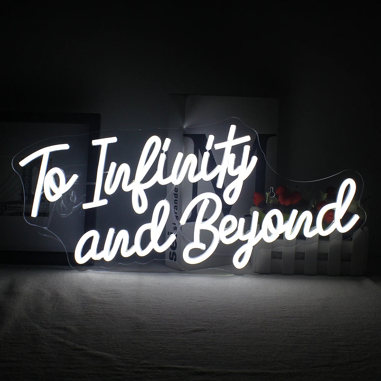 The image displays a handmade LED neon sign that reads "To Infinity and Beyond" in vibrant, glowing letters.