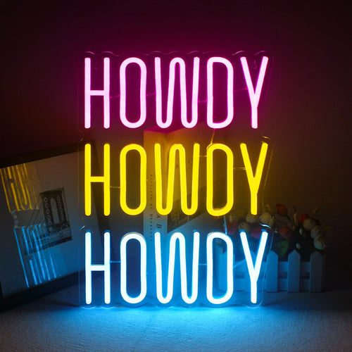 Żywy, ręcznie wykonany neon LED wyświetlający słowo „Howdy” w zabawnej, kursywnej czcionce.