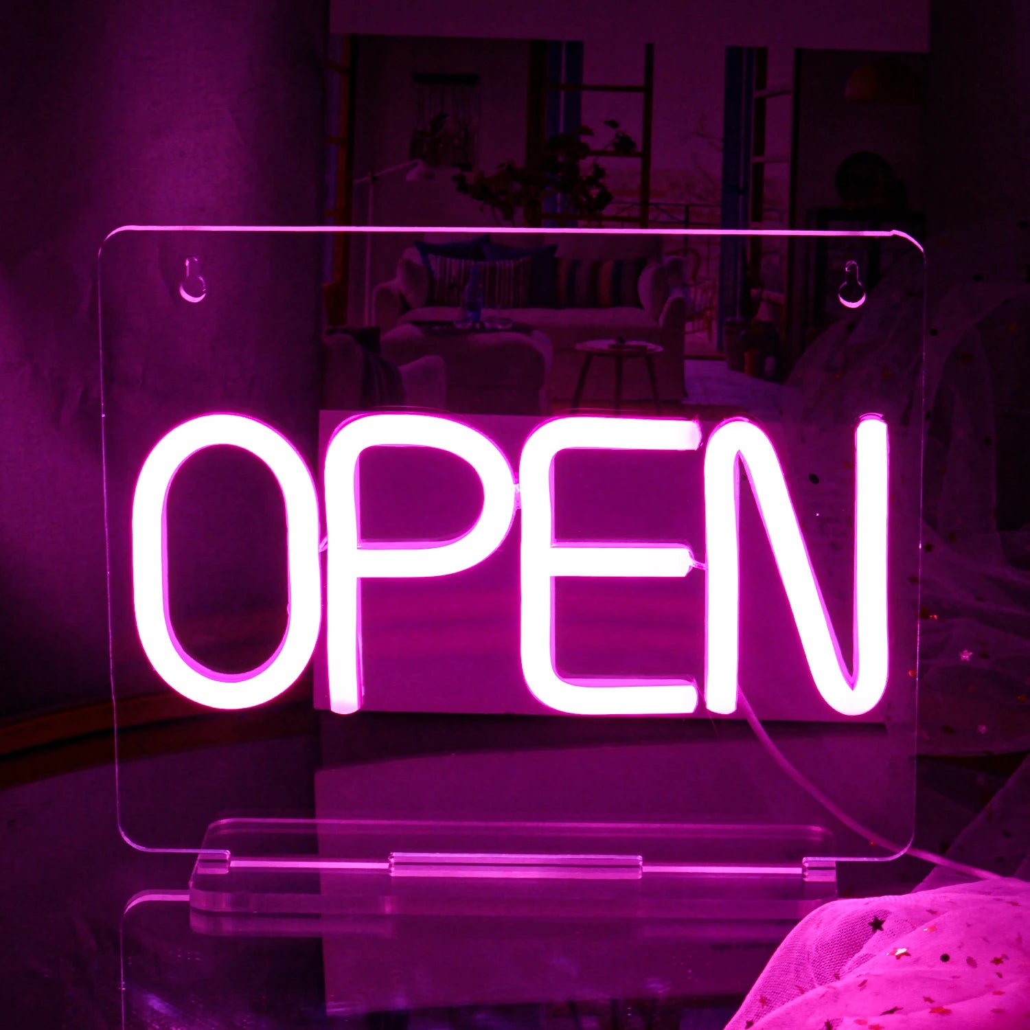 The image features a vibrant and colorful handmade LED neon sign, displaying the word "Open" in bright, luminous letters.