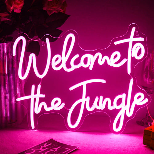 Et levende LED-neonskilt "Welcome to the Jungle" vises på en mørk baggrund.