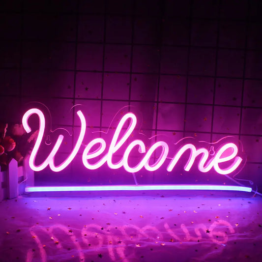 A vibrant "Welcome" LED neon sign displayed against a plain white wall.
