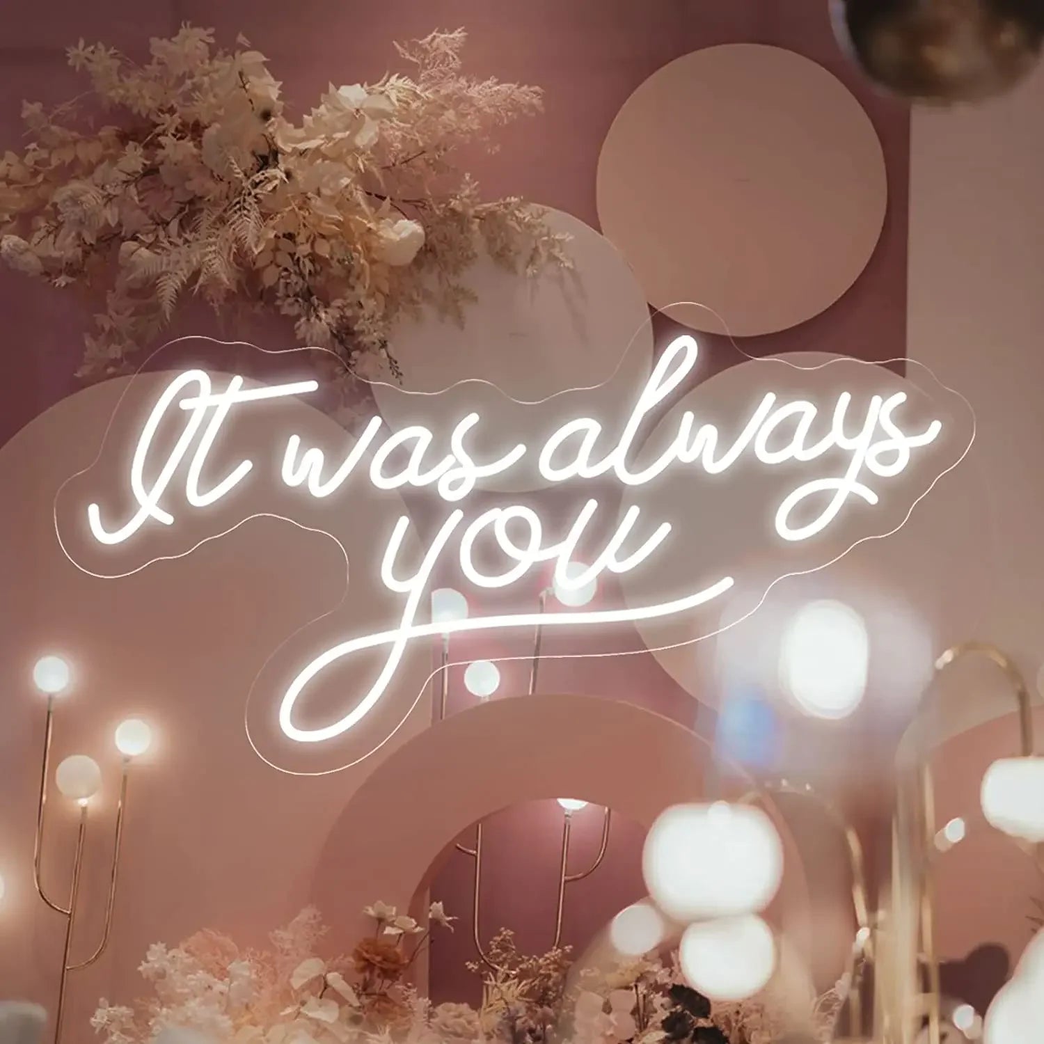 A glowing LED neon sign in a warm white hue displays the phrase "It Was Always You" in cursive handwriting.