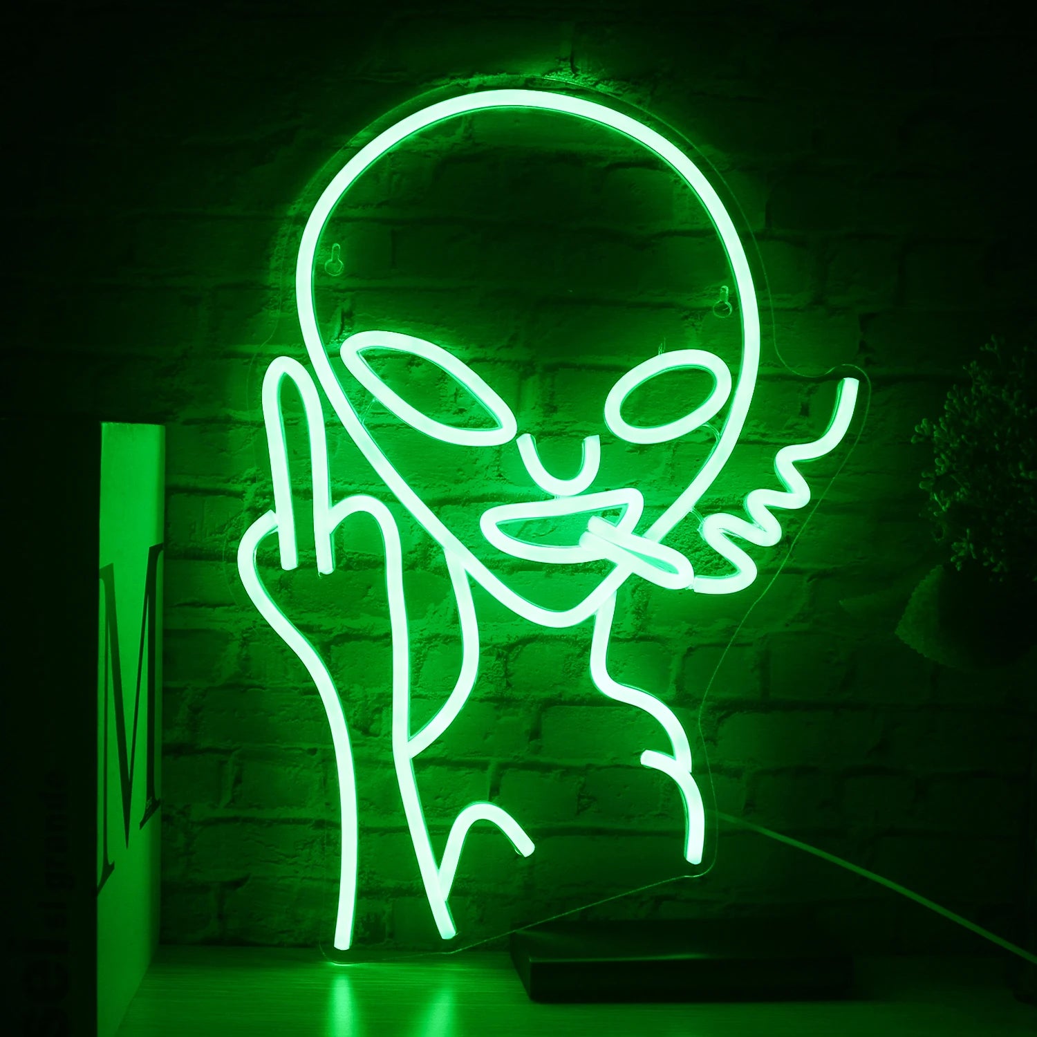 The image features a handmade LED neon sign depicting a whimsical alien character.