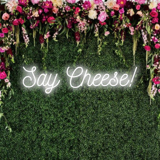 LED neon sign spelling out Say Cheese! Perfect for brightening any space with personalized neon flairs and custom design vibes.