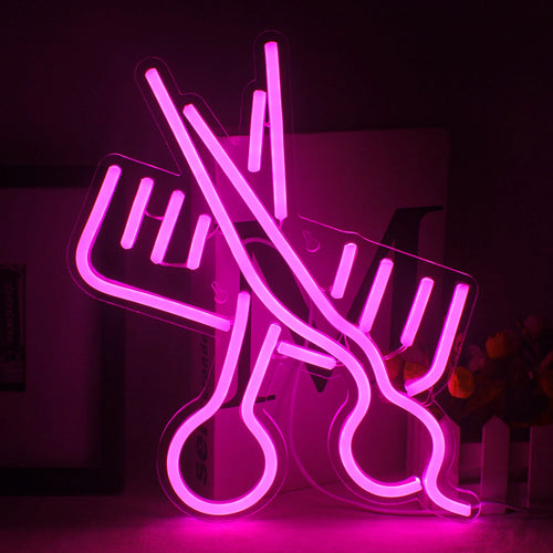 Imagen Un letrero de neón LED vibrante con la forma de un par de tijeras junto a un peine.