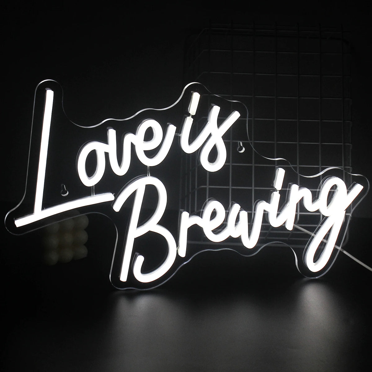 Un panneau néon LED vibrant affichant la phrase « Love is Breaking », avec une typographie audacieuse et moderne.