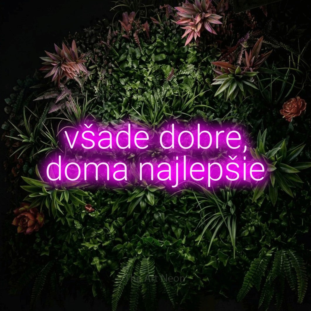 LED neon sign reading “všade dobre, doma najlepšie”, arranged in two lines.