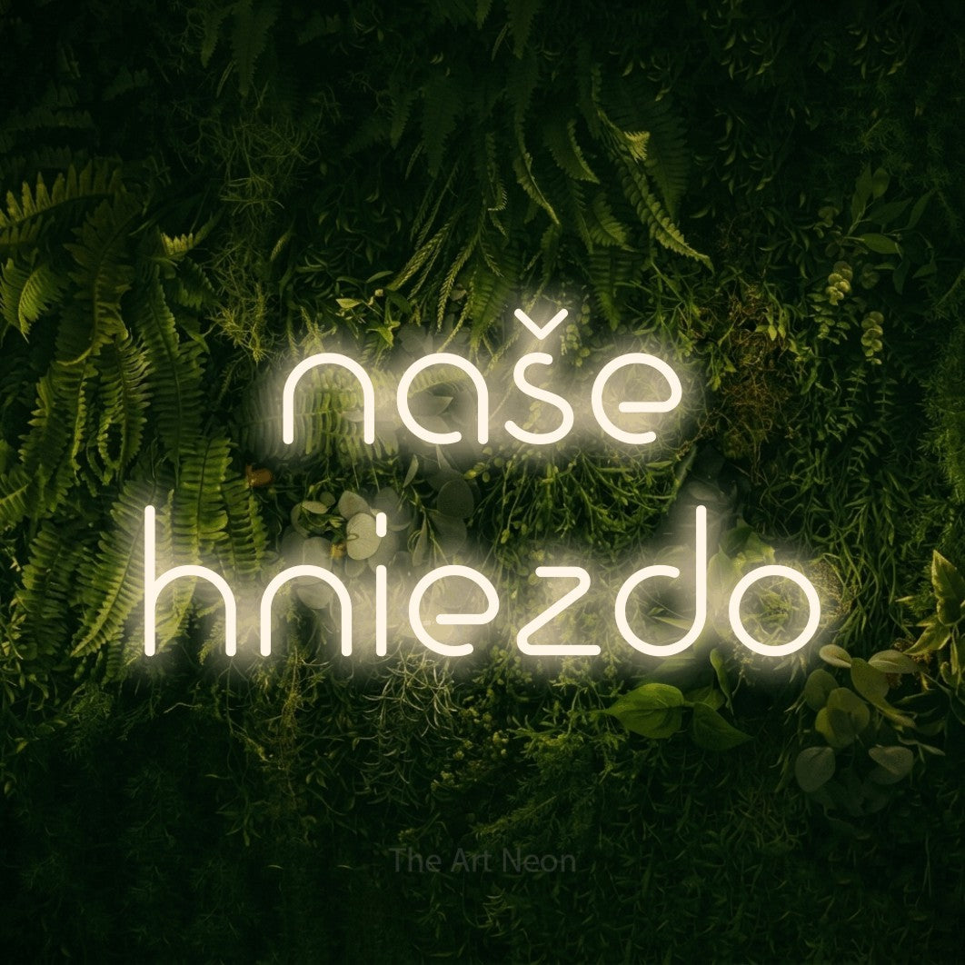 LED neon sign reading “naše hniezdo”, arranged in two lines.
