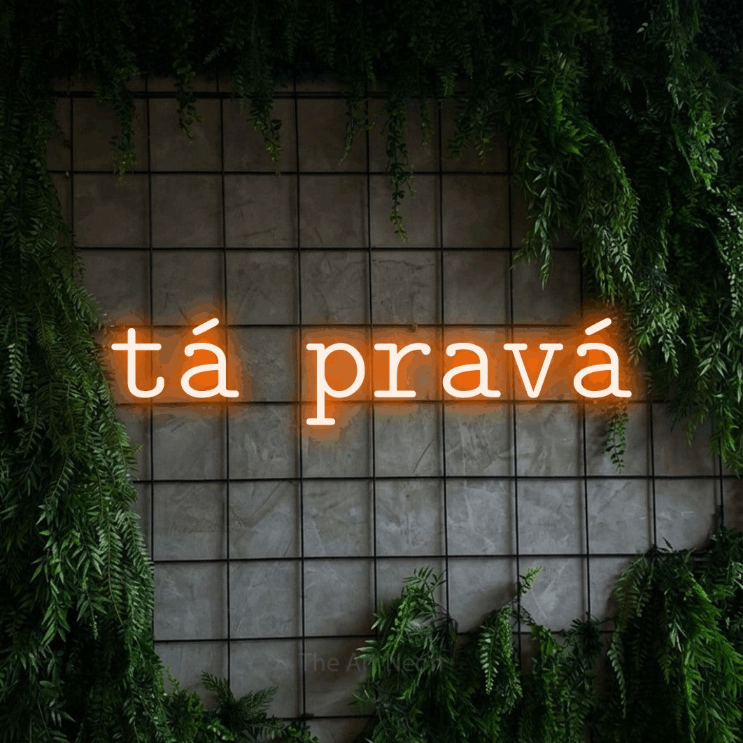 LED neon sign reading “tá pravá”, arranged in a single line.