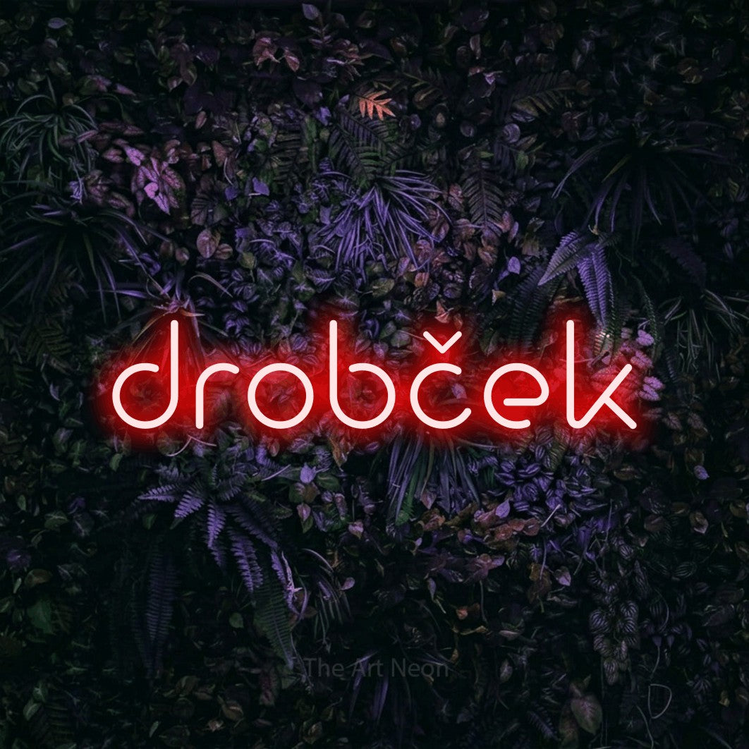 LED neon sign reading “drobček”, arranged in a single line.