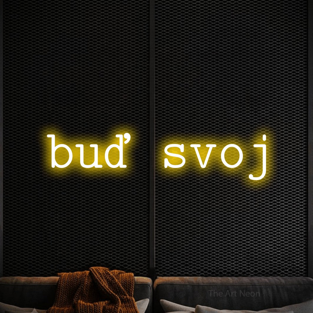 LED neon sign reading “buď svoj”, arranged in a single line.