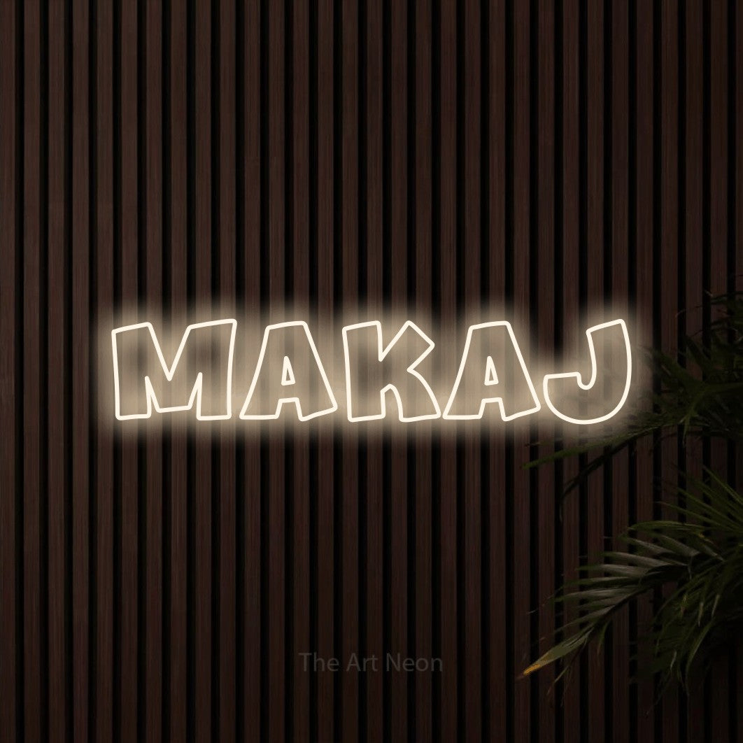 LED neon sign reading “makaj”, arranged in a single line.