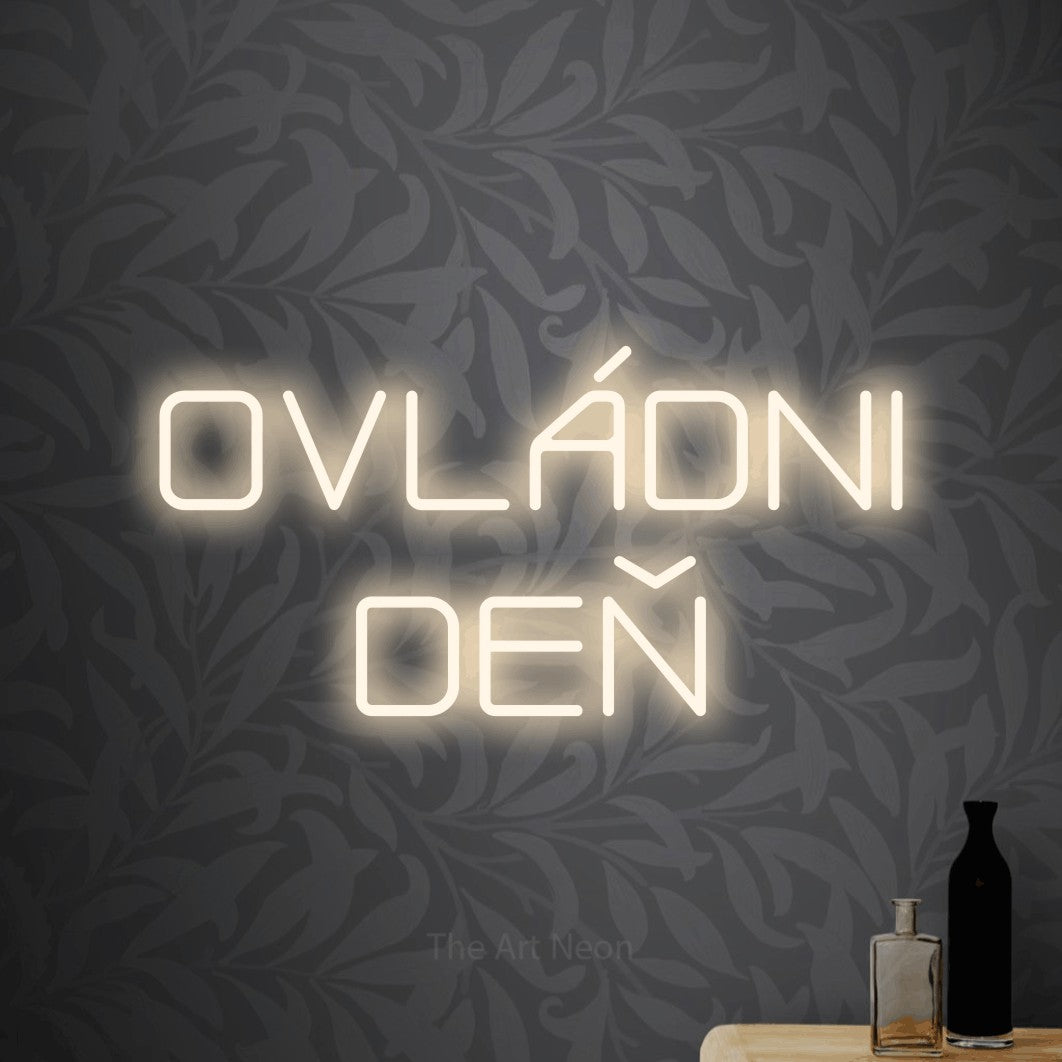 LED neon sign reading “OVLÁDNI DEŇ”, arranged in two lines.