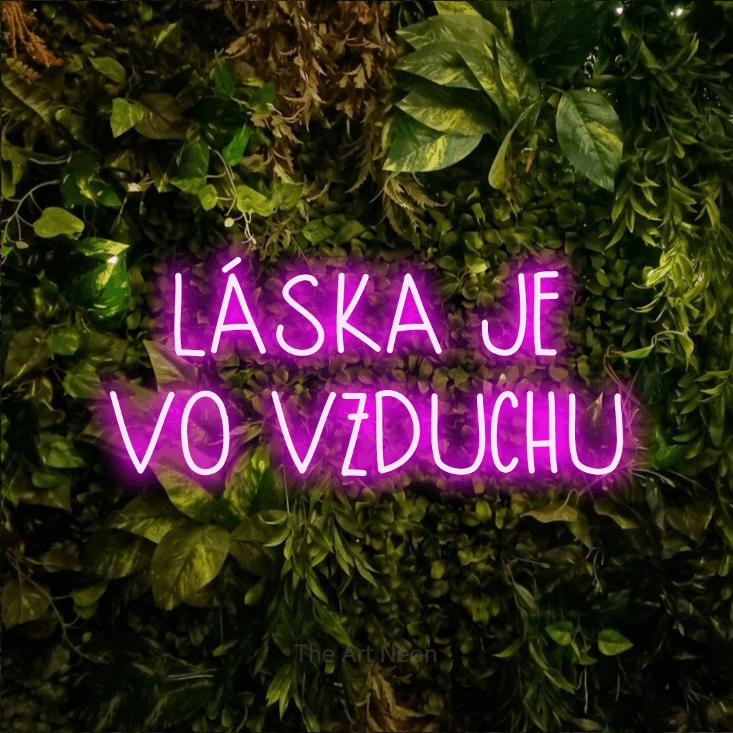 LED neon sign reading “LÁSKA JE VO VZDUCHU”, arranged in two lines.