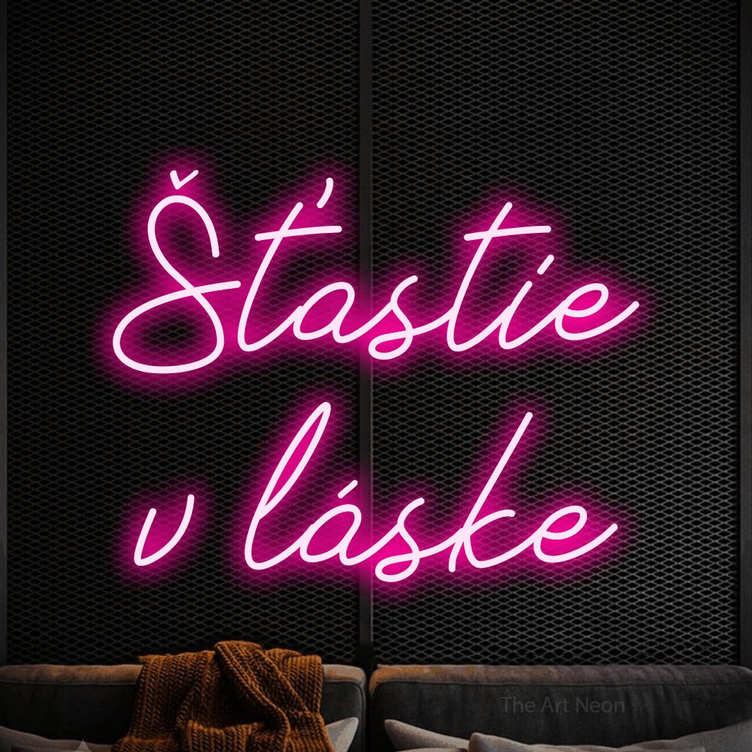 LED neon sign reading “Šťastie v láske”, arranged in two lines.
