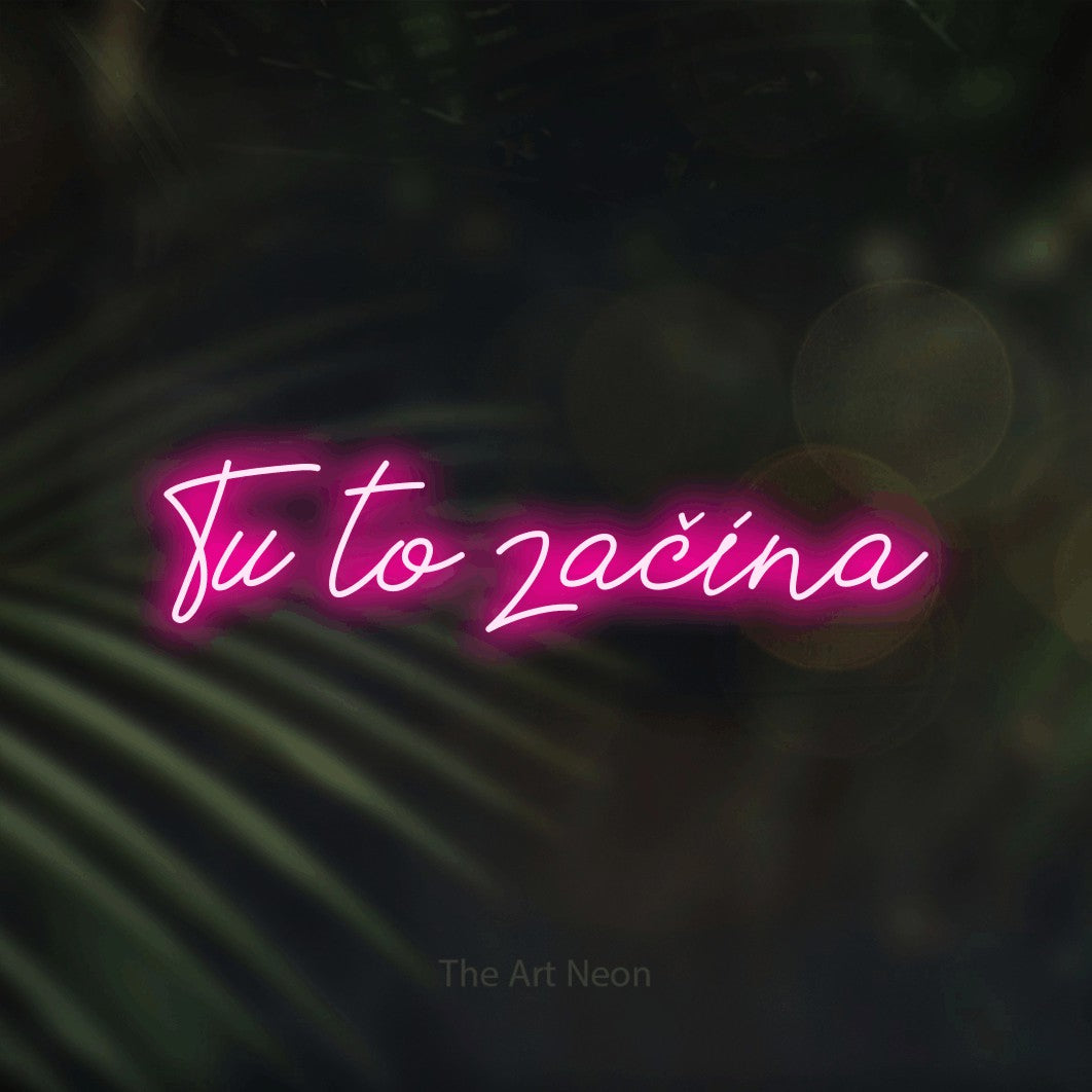 LED neon sign reading “Tu to začína”, arranged in a single line.