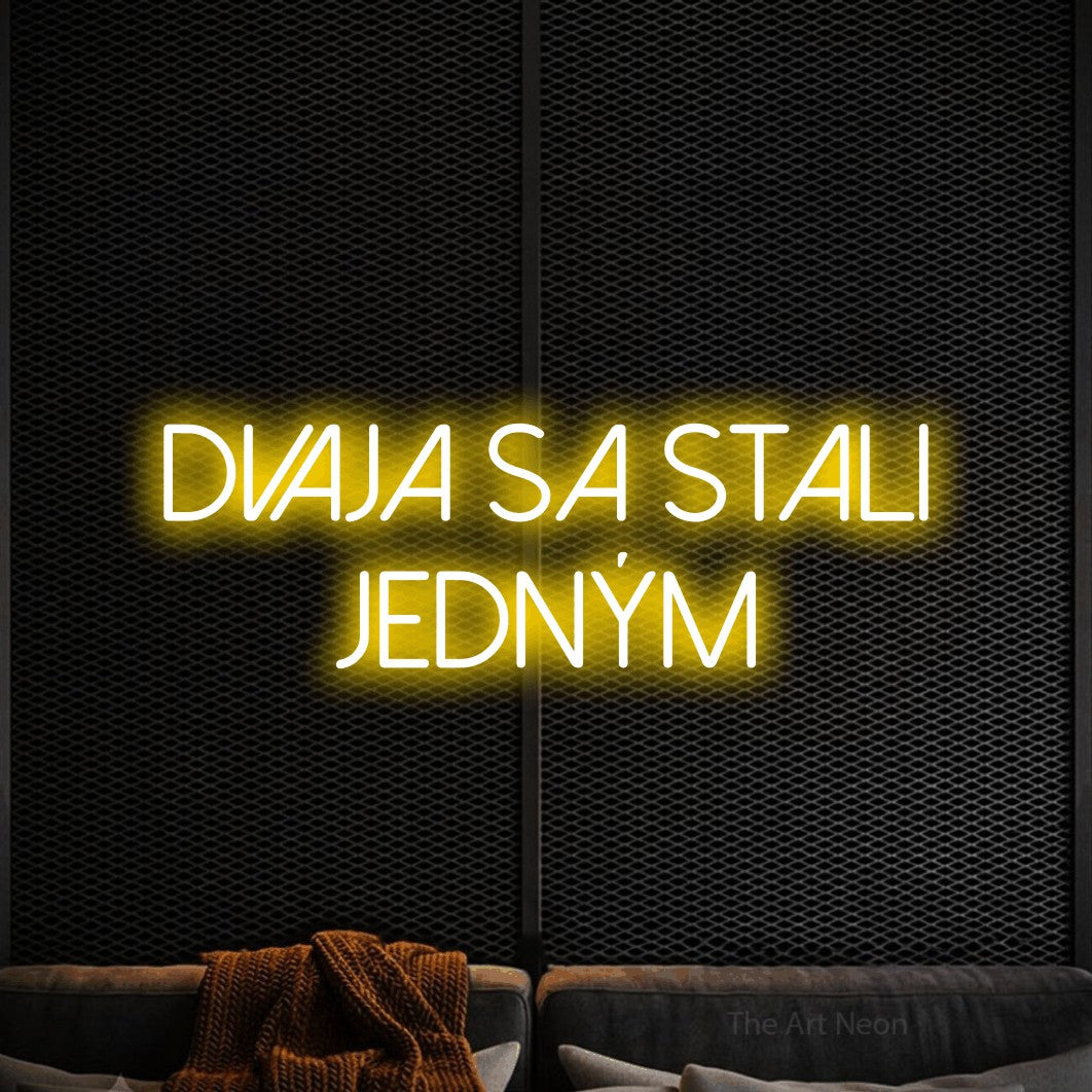LED neon sign reading “dvaja sa stali jedným”, arranged in two lines.